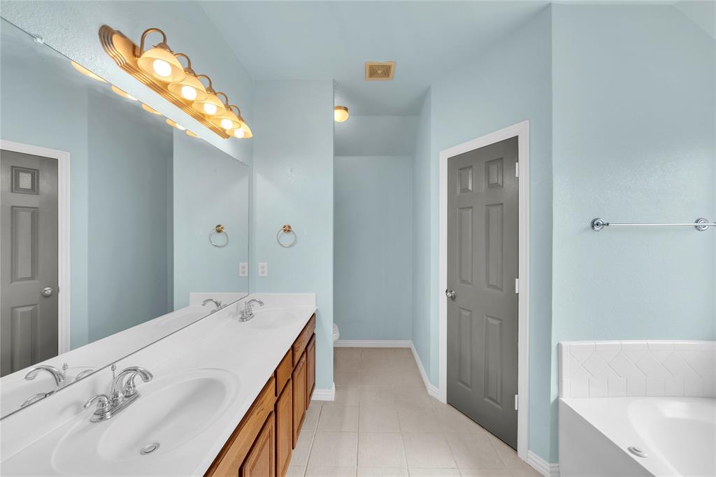 16055 Prairie Meadow Forney, TX 75126 - Photo 10 of 33 a bathroom with a tub sink and mirror