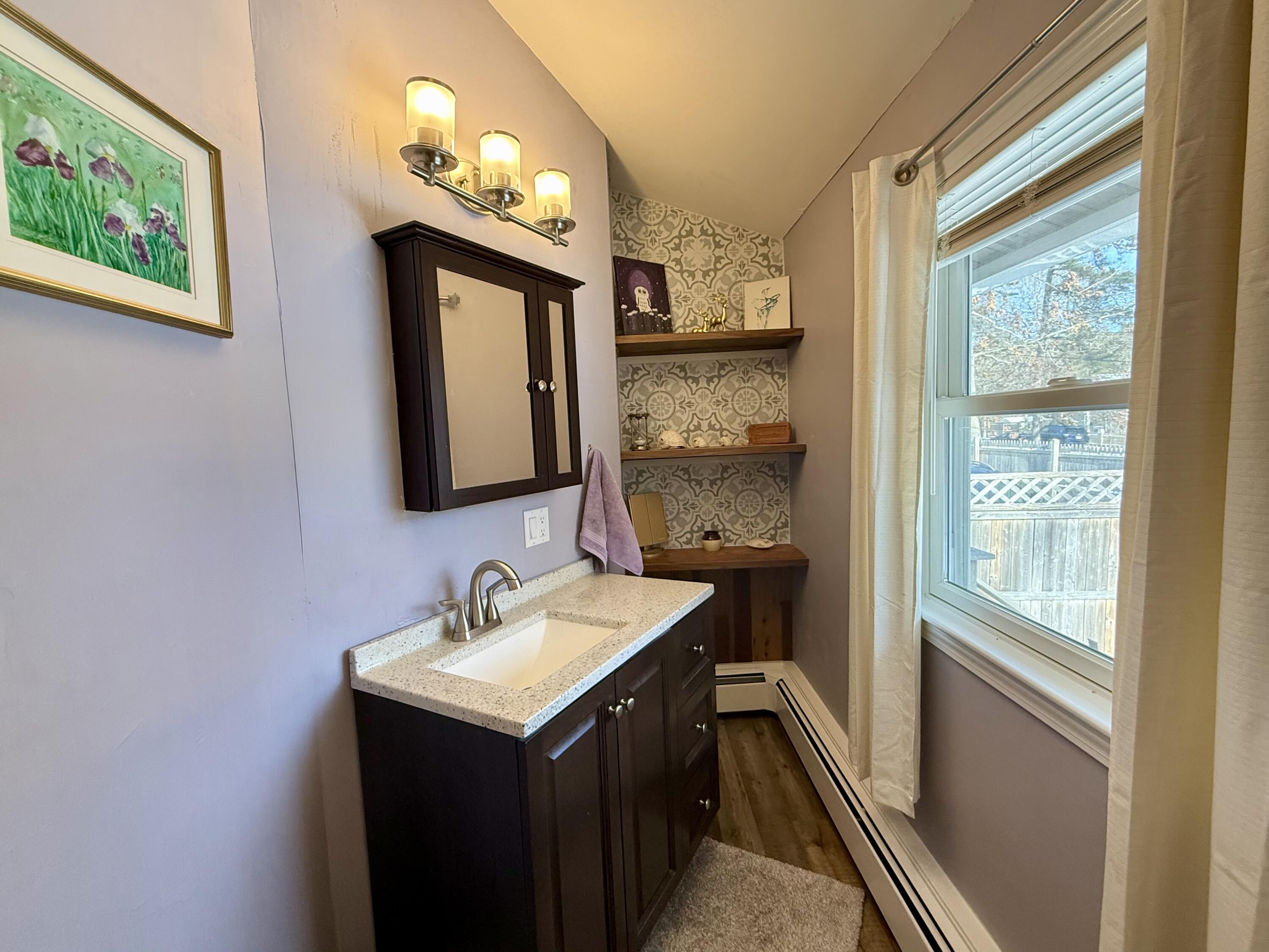 60 Ashumet Avenue Mashpee, MA 02649 - Photo 24 of 30 a bathroom with a sink and a mirror