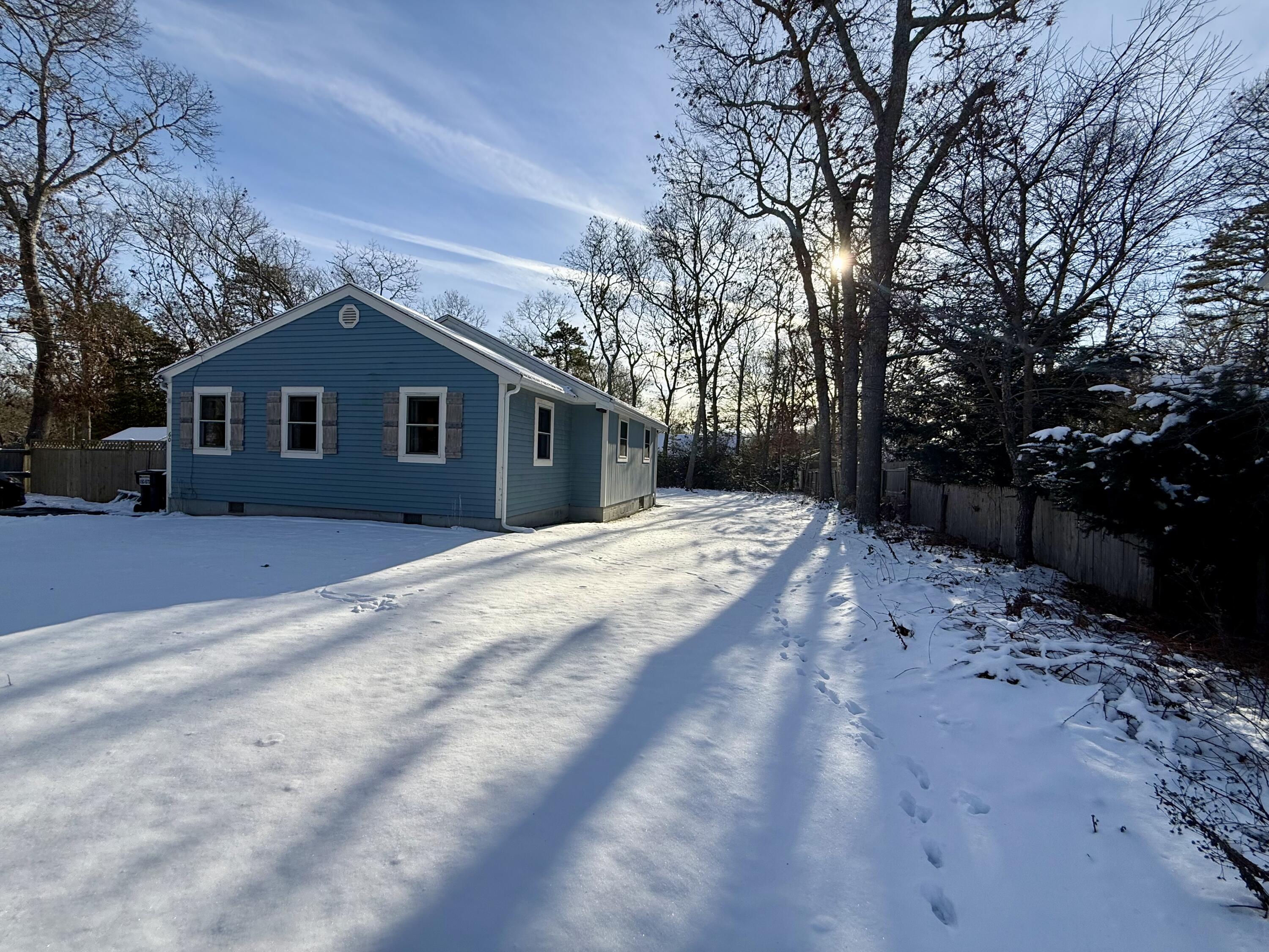 60 Ashumet Avenue Mashpee, MA 02649 - Photo 3 of 30 a front view of a house with a yard covered in snow