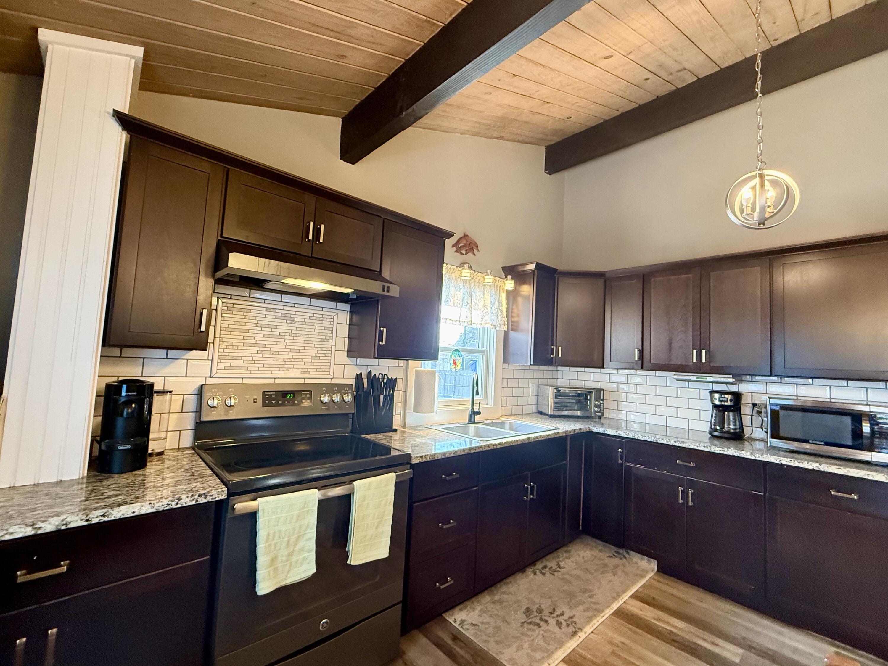 60 Ashumet Avenue Mashpee, MA 02649 - Photo 10 of 30 a kitchen with a sink and a stove