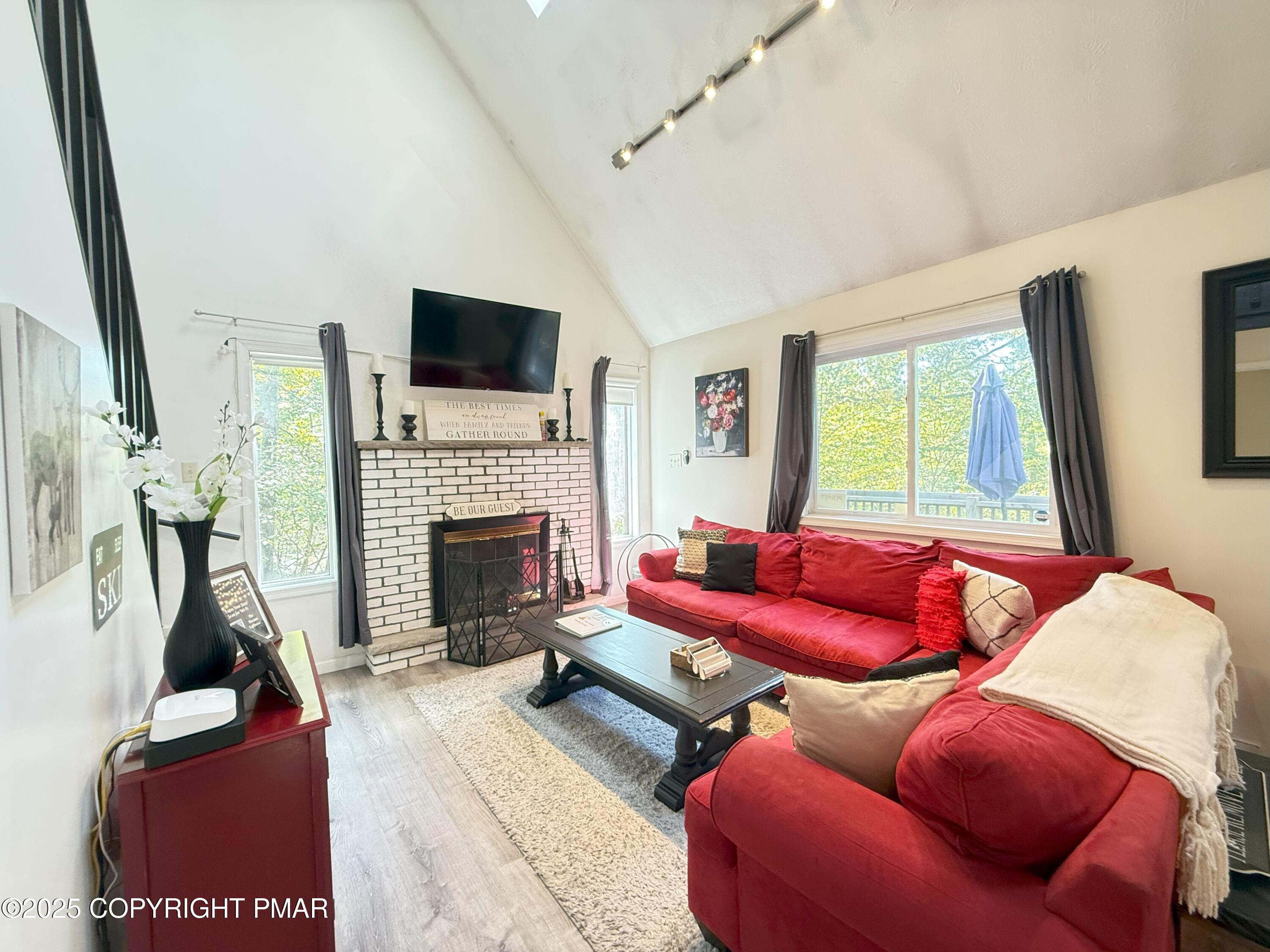 1026 Hampstead Road Bushkill, PA 18324 - Photo 11 of 61 a living room with furniture a flat screen tv and a fireplace