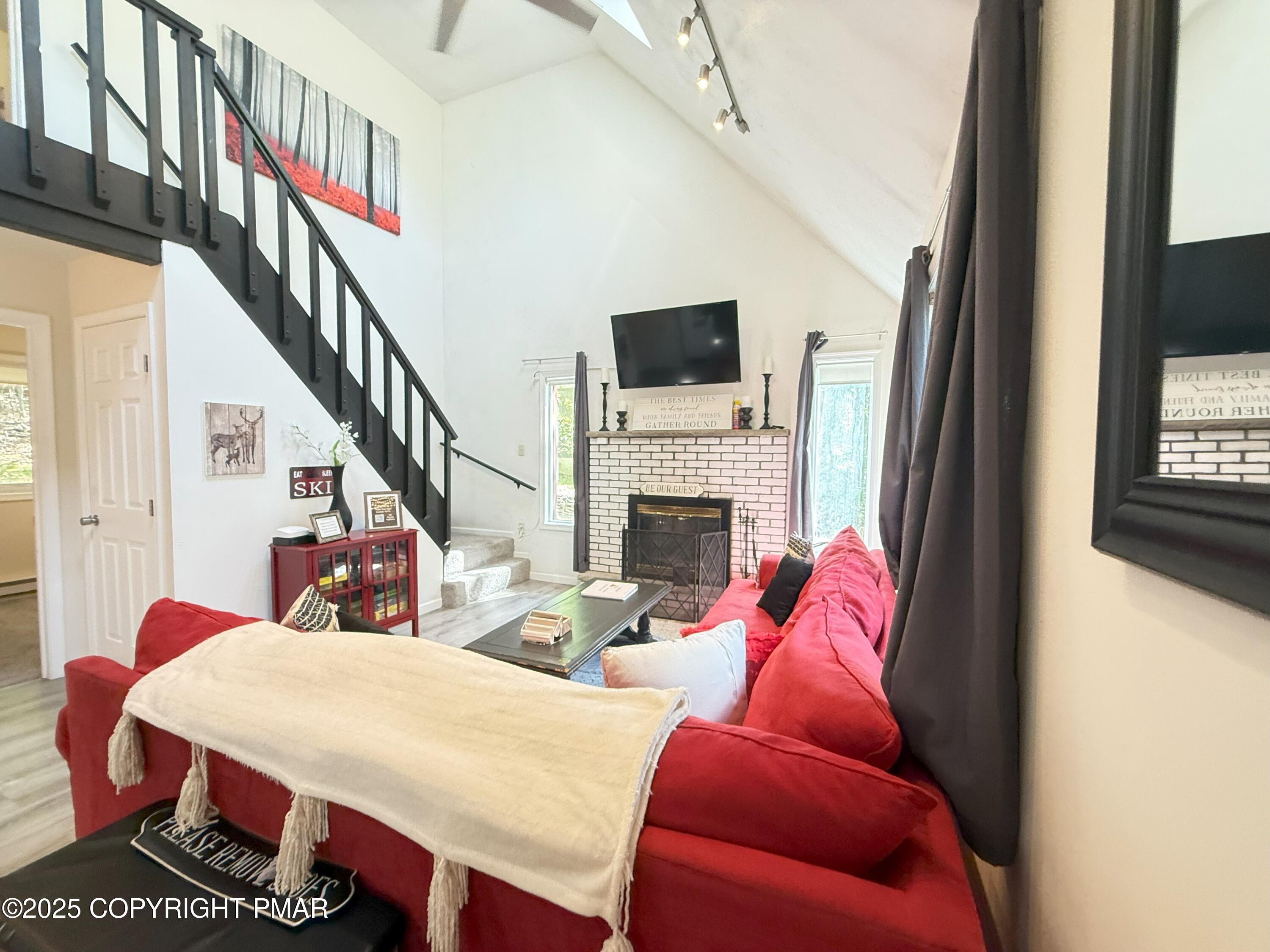 1026 Hampstead Road Bushkill, PA 18324 - Photo 12 of 61 a living room with furniture a flat screen tv and a fireplace