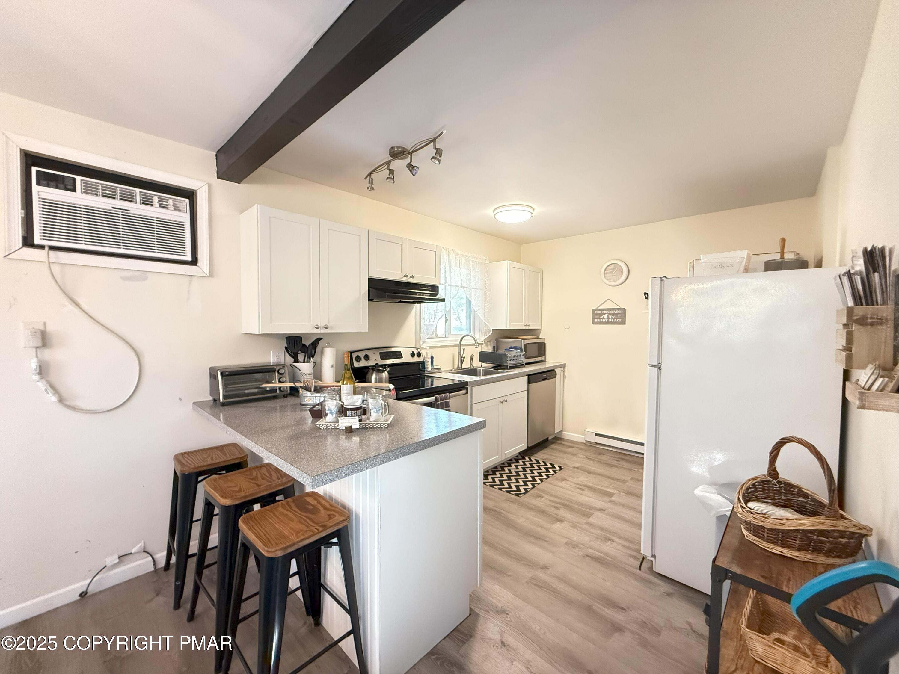 1026 Hampstead Road Bushkill, PA 18324 - Photo 17 of 61 a kitchen with stainless steel appliances granite countertop a refrigerator sink and white cabinets