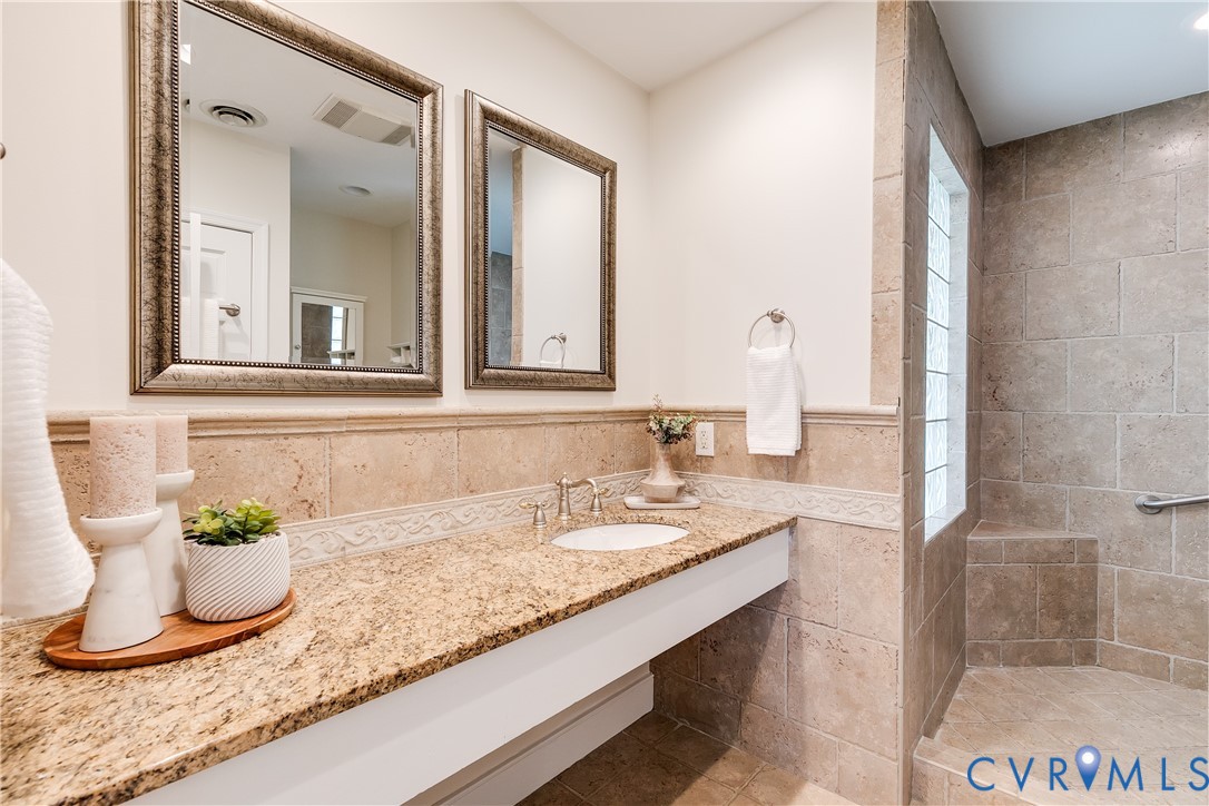 609 Baldwin Road Henrico, VA 23229 - Photo 12 of 50 a bathroom with a granite countertop sink and a mirror