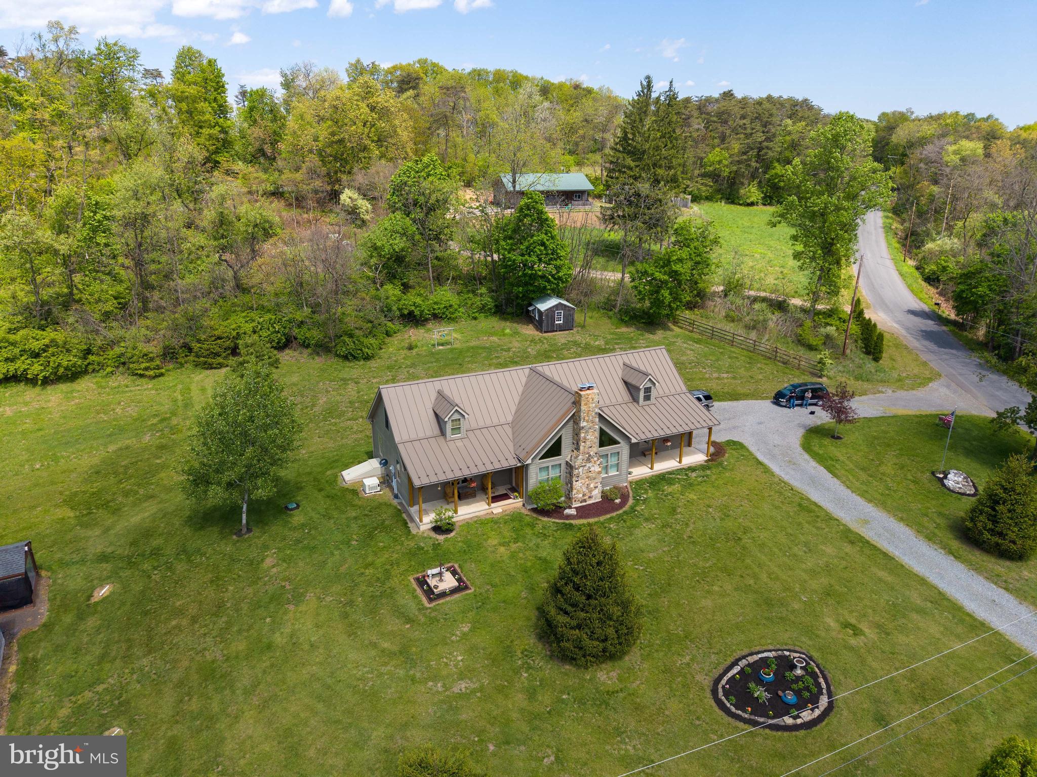 1020 Clark Hill Road Mount Pleasant Mills, PA 17853 - Photo 1 of 76 an aerial view of a house with garden space and trees in the back