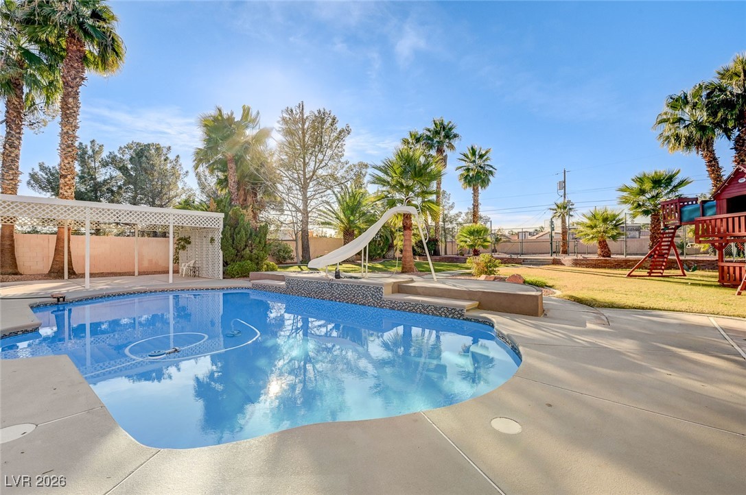 2955 El Camino Road Las Vegas, NV 89146 - Photo 89 of 99 View of pool featuring a water slide, a playground, and a patio area