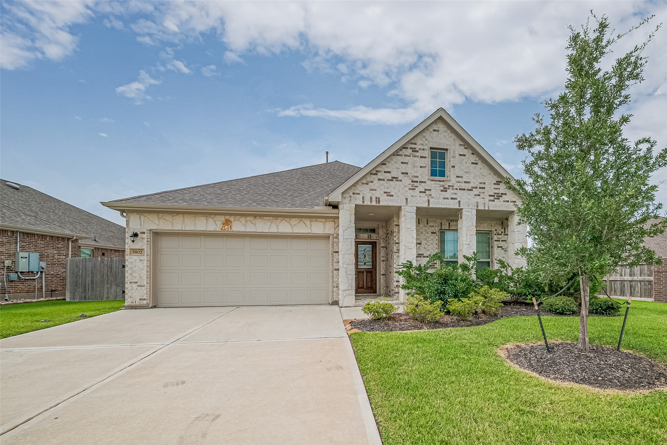 5802 Ashland Lane Pasadena, TX 77505 - Photo 1 of 50 a front view of a house with a garden and trees