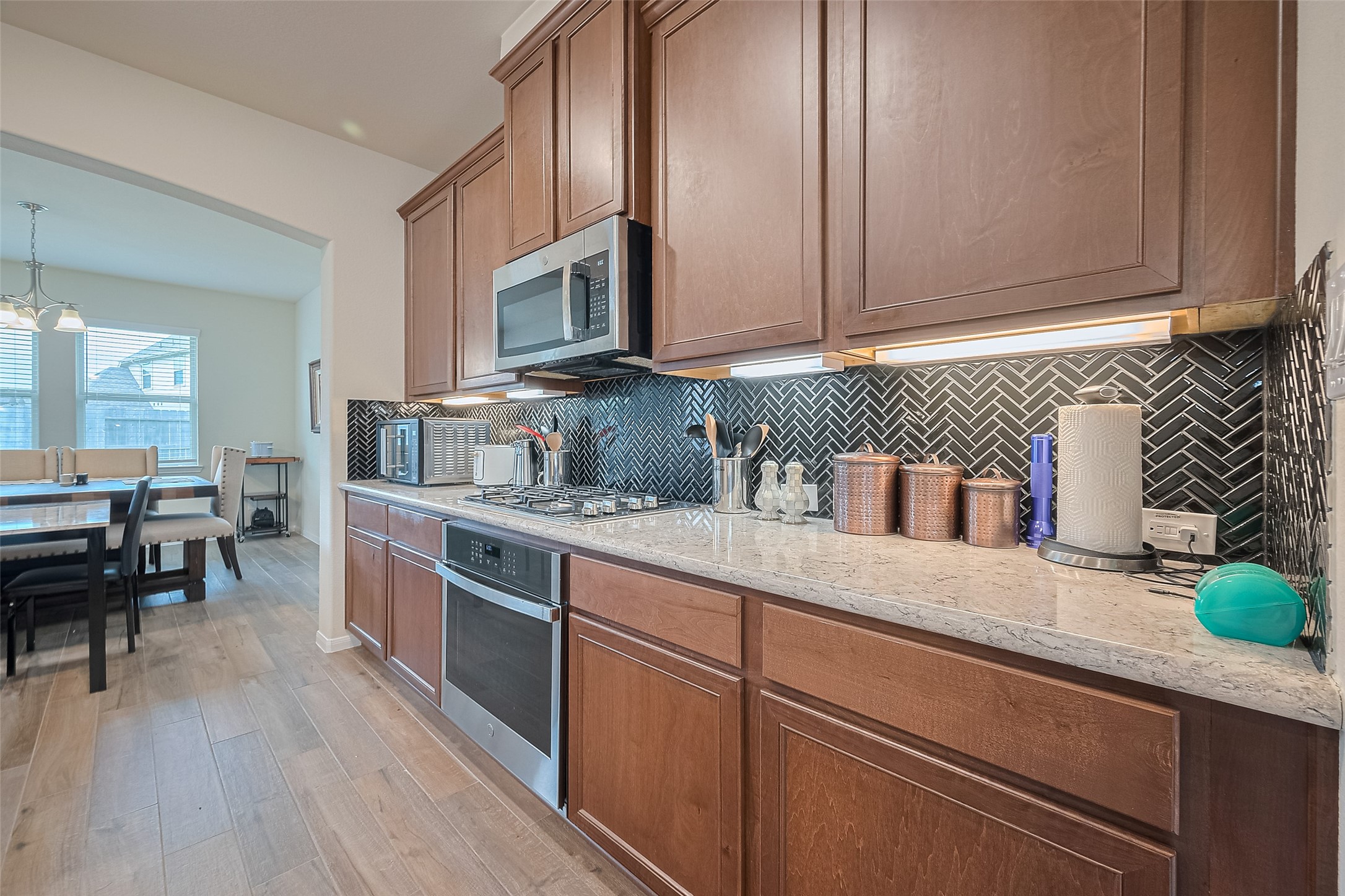 5802 Ashland Lane Pasadena, TX 77505 - Photo 13 of 50 a kitchen with stainless steel appliances granite countertop a stove a sink and a microwave
