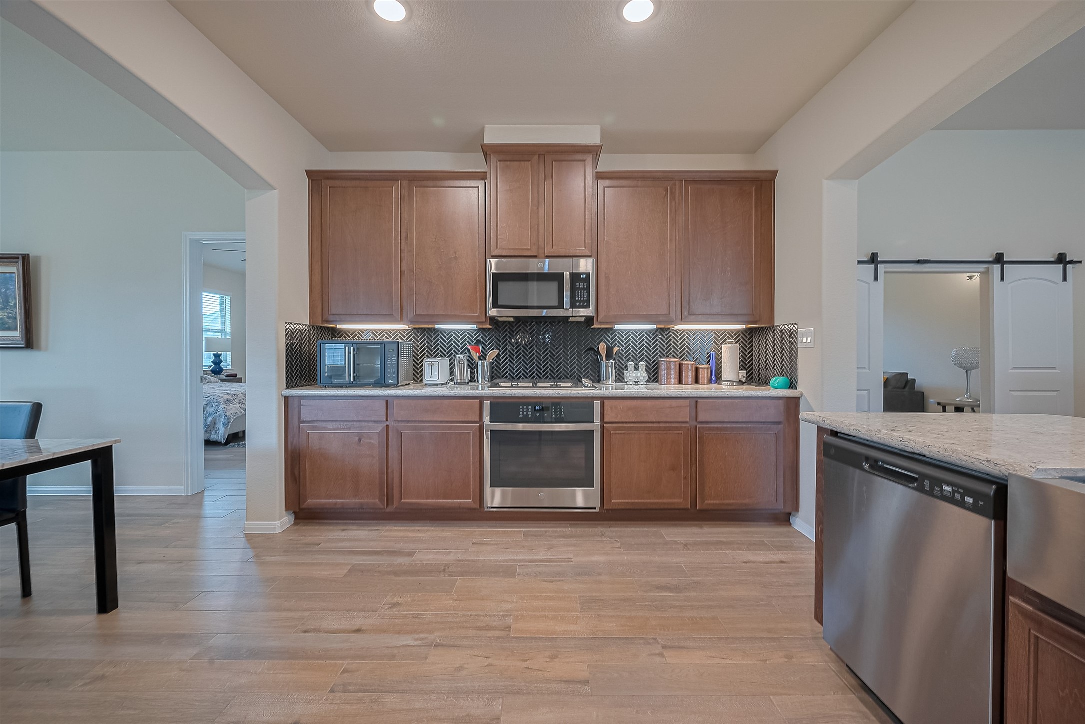 5802 Ashland Lane Pasadena, TX 77505 - Photo 17 of 50 a kitchen with stainless steel appliances a stove a sink and a refrigerator