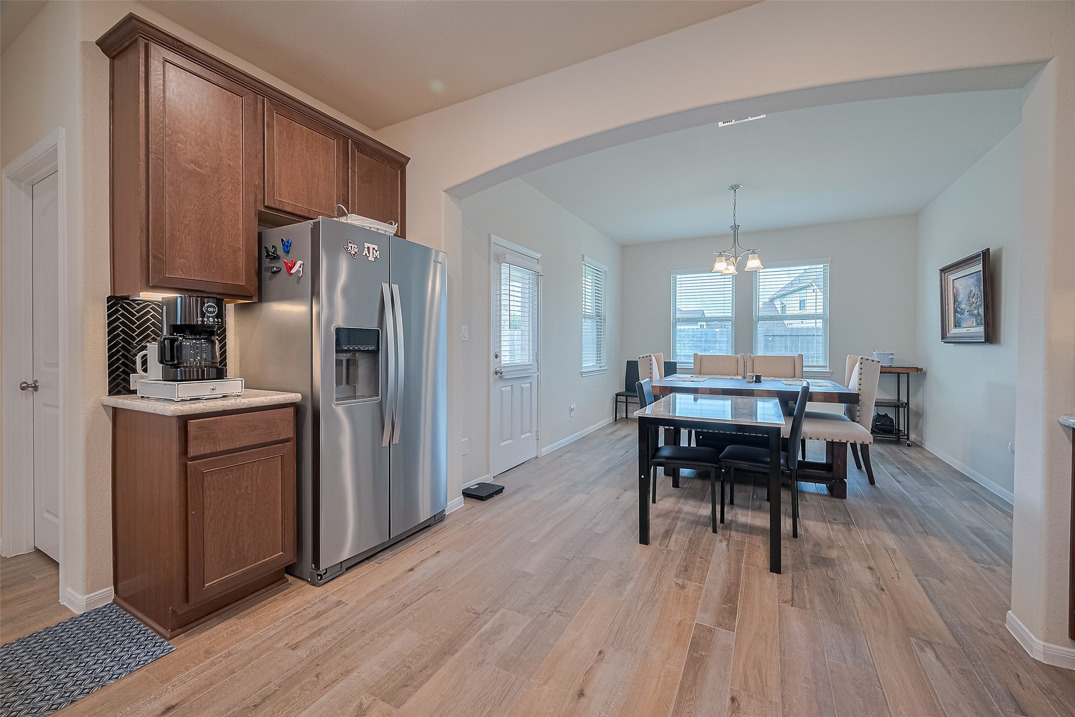 5802 Ashland Lane Pasadena, TX 77505 - Photo 18 of 50 a kitchen with a table chairs refrigerator and cabinets