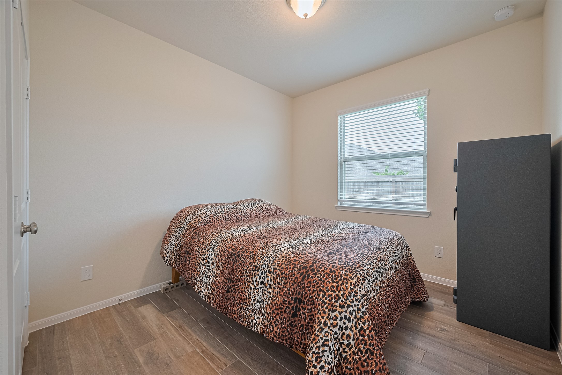 5802 Ashland Lane Pasadena, TX 77505 - Photo 30 of 50 a bedroom with a bed and wooden floor