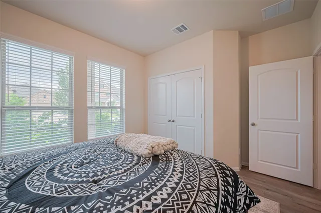 a bedroom with a bed and a window