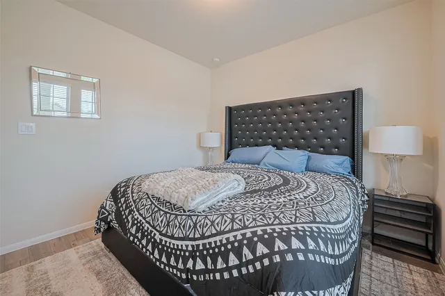 a bedroom with a bed and wooden floor