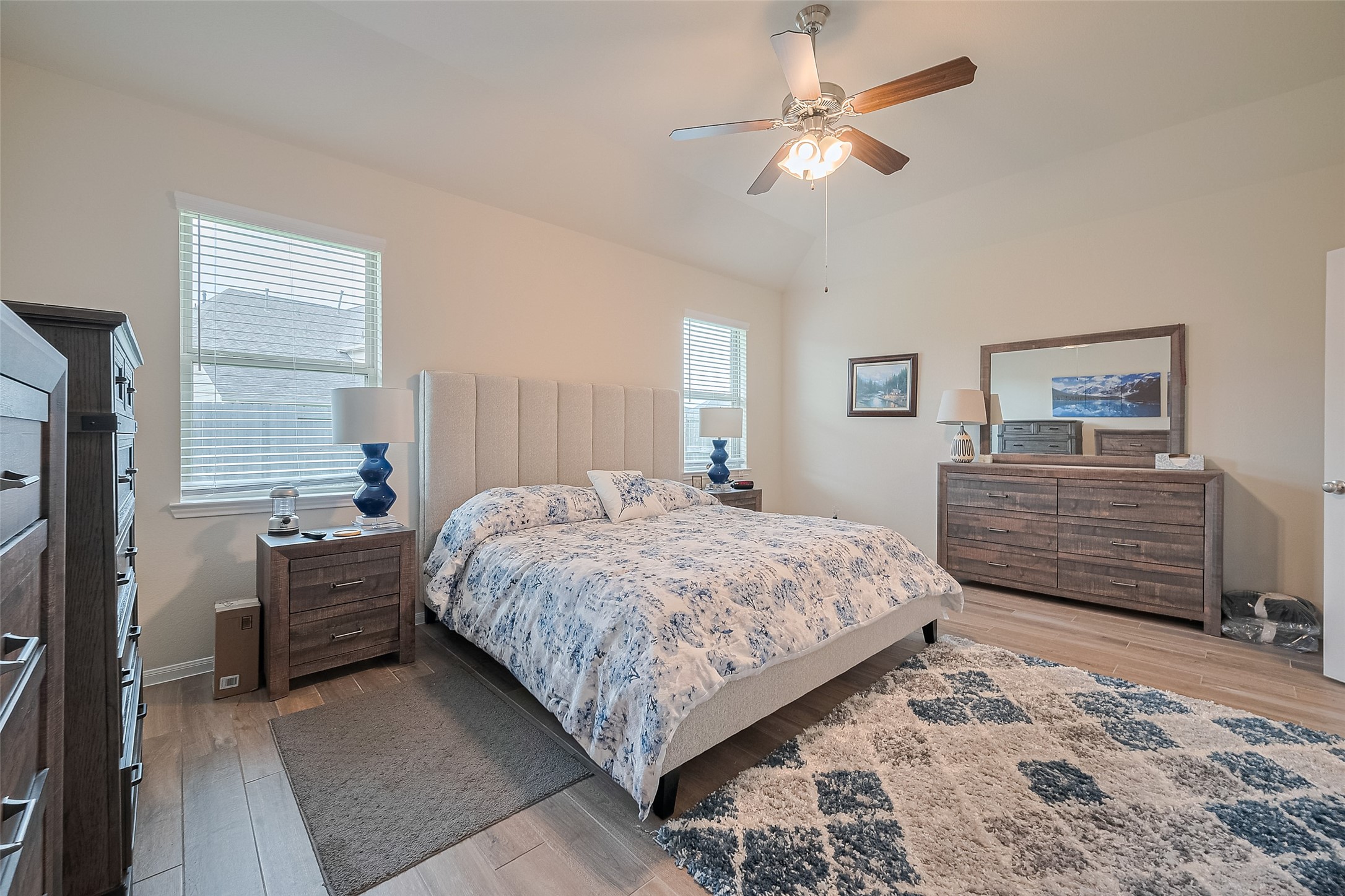 5802 Ashland Lane Pasadena, TX 77505 - Photo 37 of 50 a bedroom with a bed a dresser and a chandelier