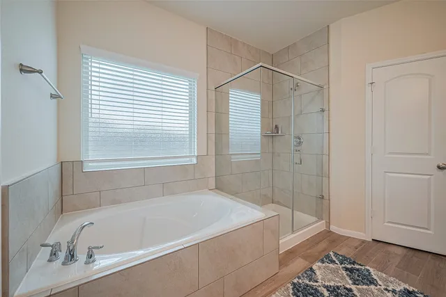 a bathroom with a bathtub and a shower