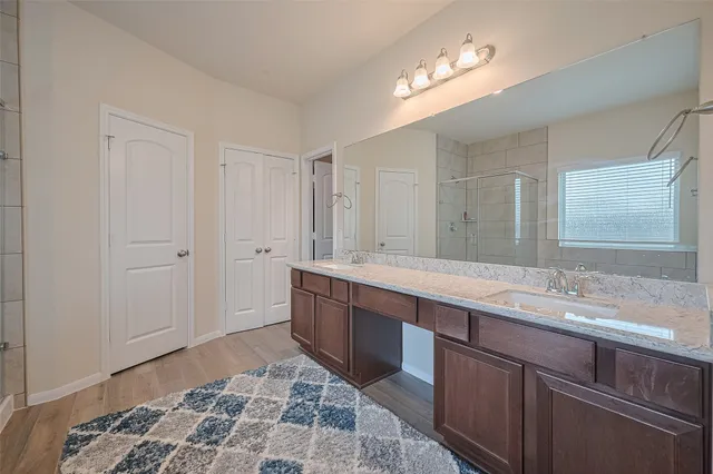 a spacious bathroom with a double vanity sink and a mirror