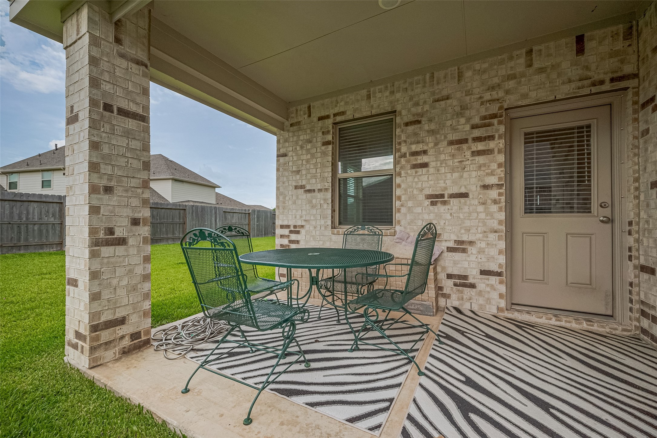 5802 Ashland Lane Pasadena, TX 77505 - Photo 49 of 50 a view of a patio with table and chairs with wooden floor and plants