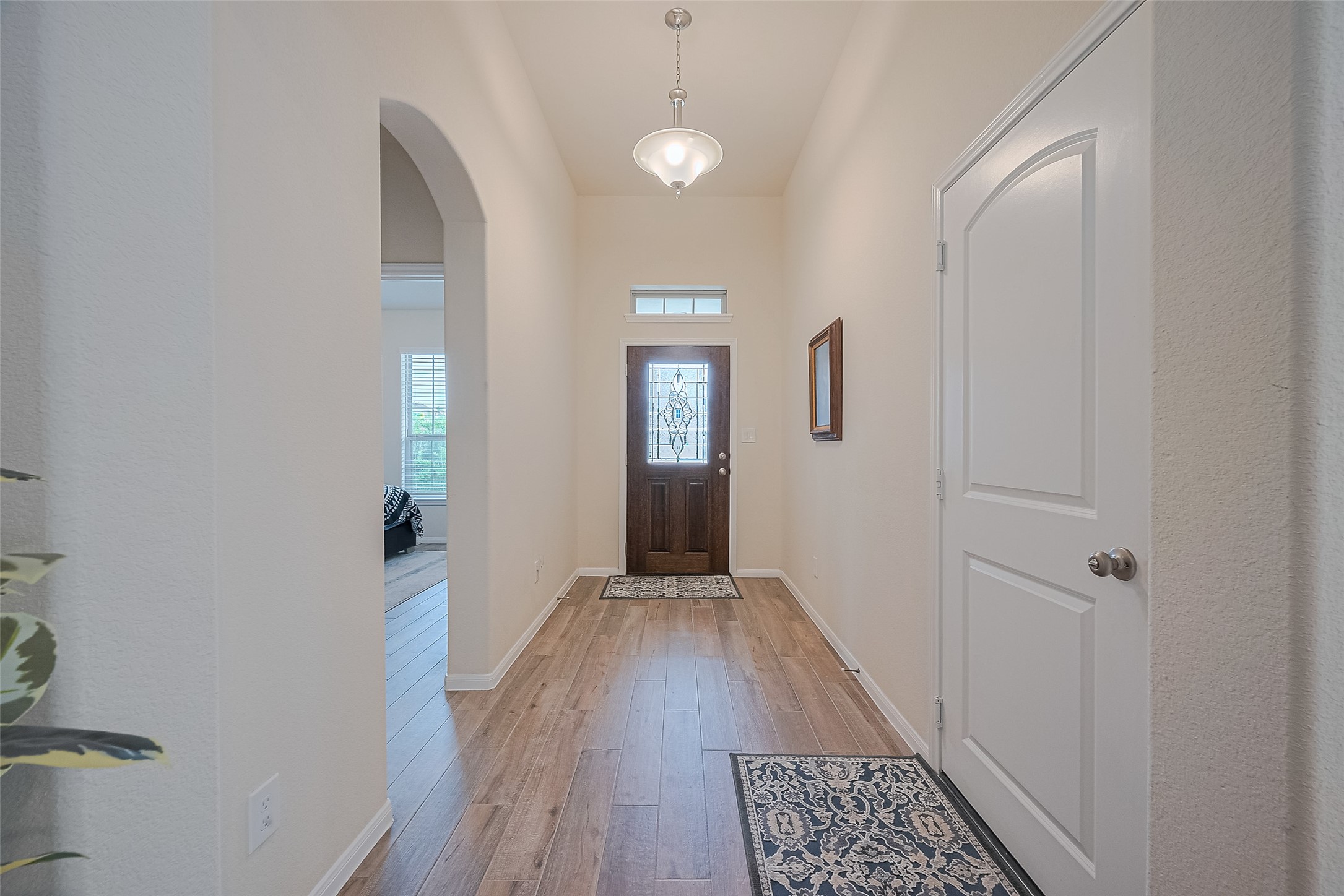 5802 Ashland Lane Pasadena, TX 77505 - Photo 6 of 50 a view of a hallway with wooden floor and a bathroom