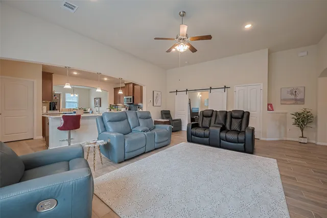 a living room with furniture and a chandelier
