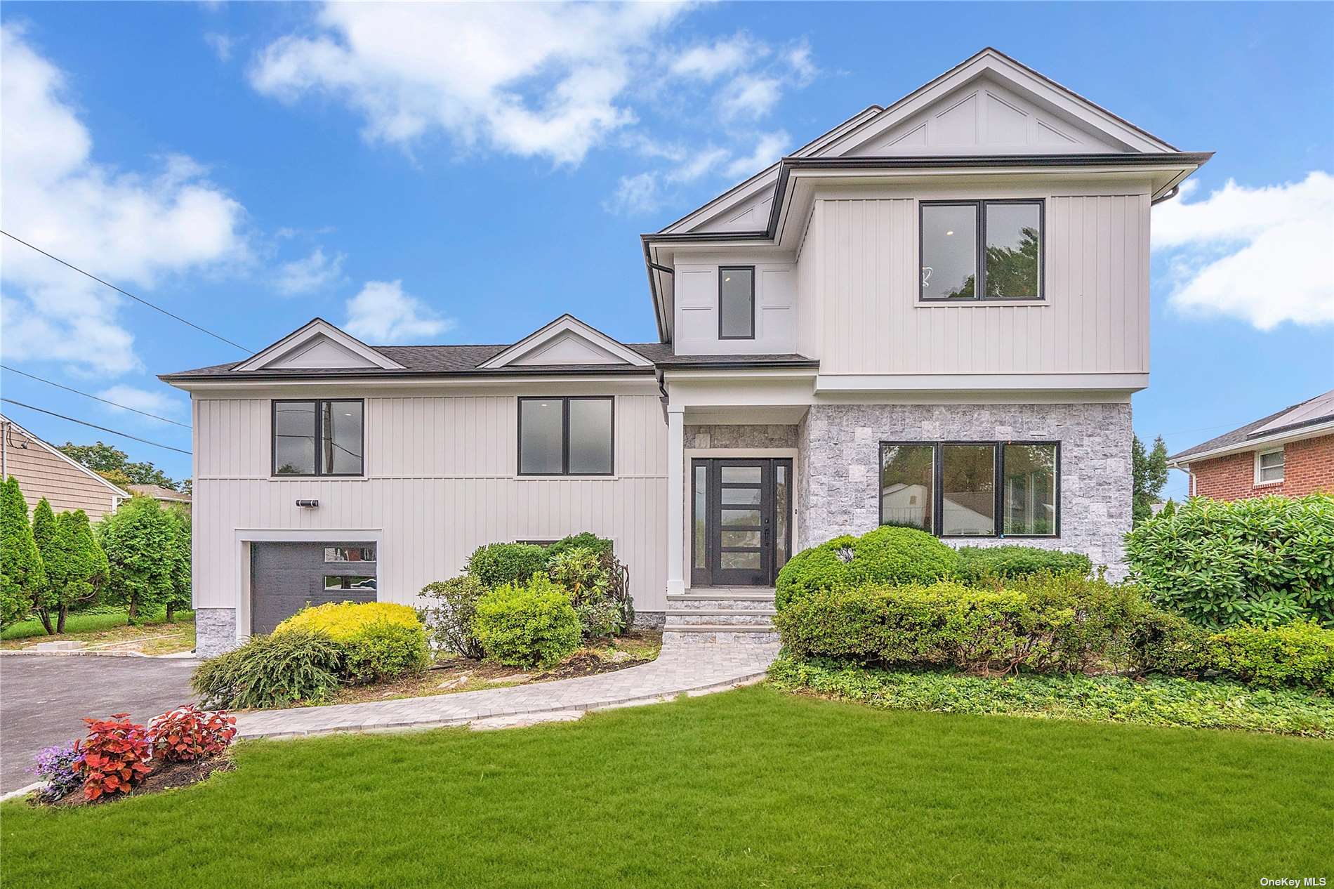 a front view of a house with a garden