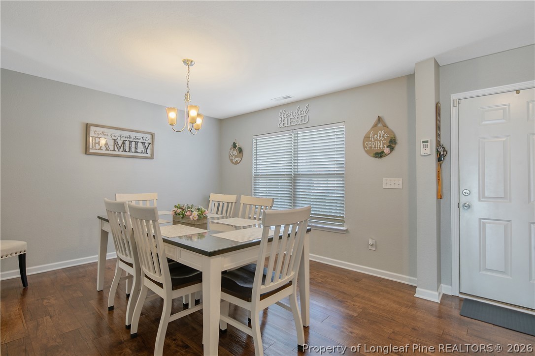 340 Battery Way Bunnlevel, NC 28323 - Photo 6 of 50 a view of a dining room with furniture and wooden floor