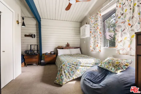 a bedroom with bed and window