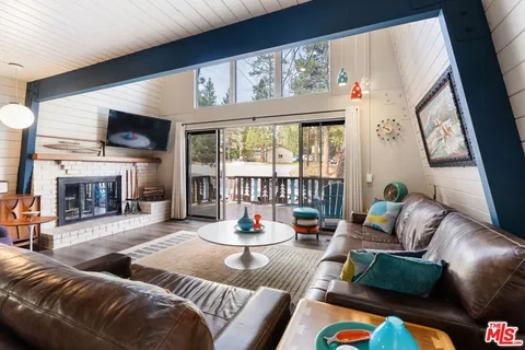 a living room with furniture fireplace and flat screen tv