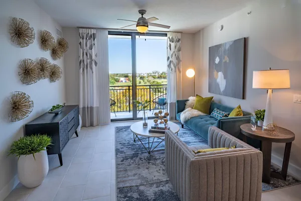 a living room with furniture and a chandelier
