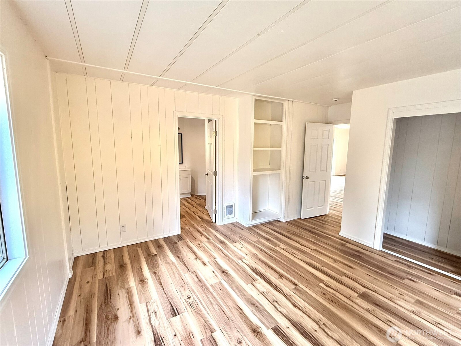 22513 South Forest Loop Road Granite Falls, WA 98252 - Photo 19 of 39 a view of a bedroom with wooden floor and a bathroom
