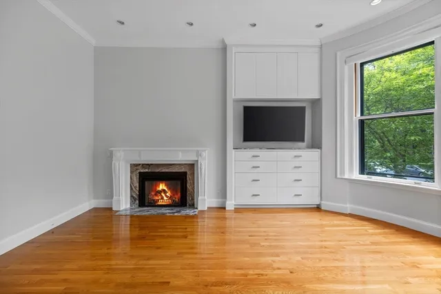 a view of an empty room with a fireplace