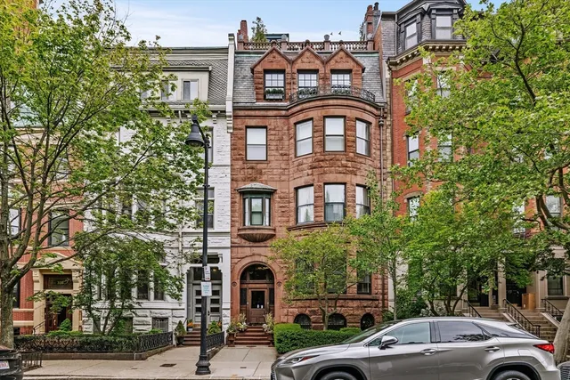 a front view of a building with trees