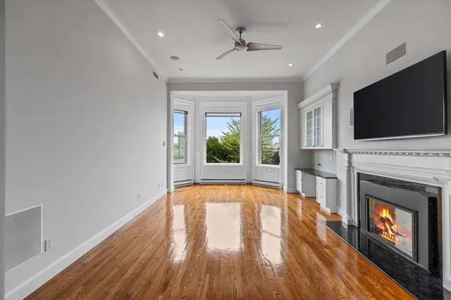 a view of an empty room with a fireplace and a window