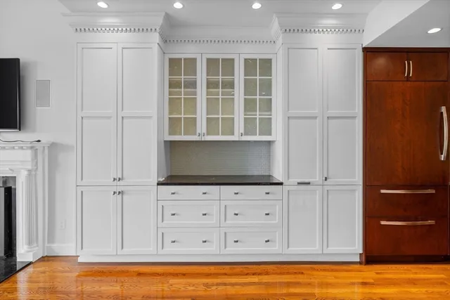 a view of empty room with wooden floor and cabinet