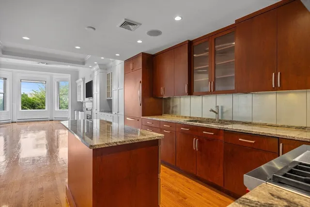 a kitchen with stainless steel appliances granite countertop a sink and a counter top space
