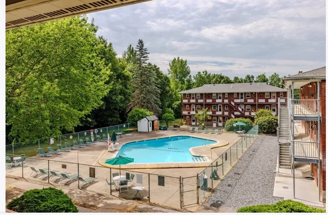 a view of a chairs and table in backyard