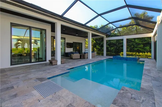 a view of a patio with a table and chairs under an umbrella