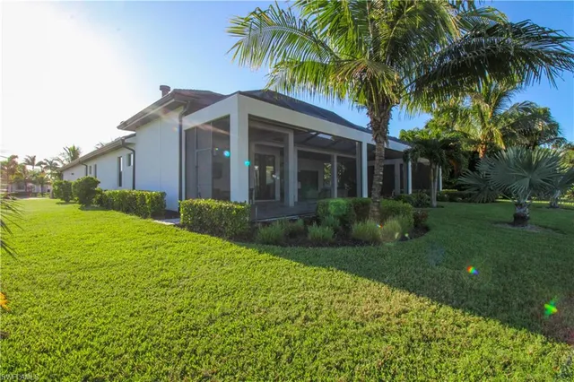a view of a house with a yard and potted plants