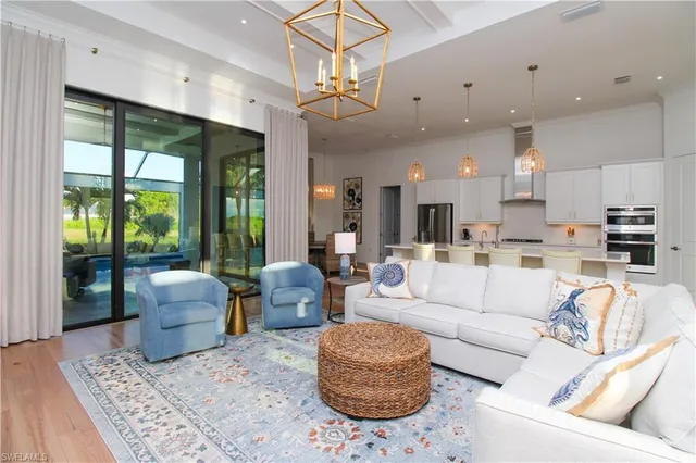 a living room with furniture and a chandelier