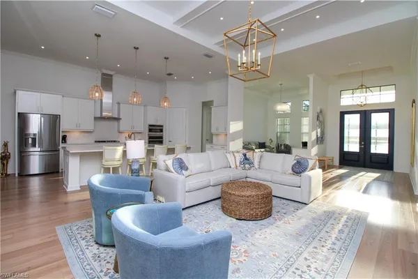 a living room with furniture a chandelier and a chandelier