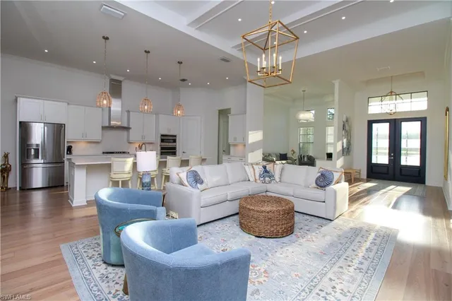 a living room with furniture a chandelier and a chandelier