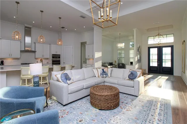 a living room with furniture and a chandelier