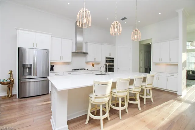 a kitchen with a dining table chairs and refrigerator