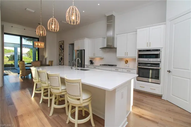 a kitchen with a dining table cabinets and stainless steel appliances