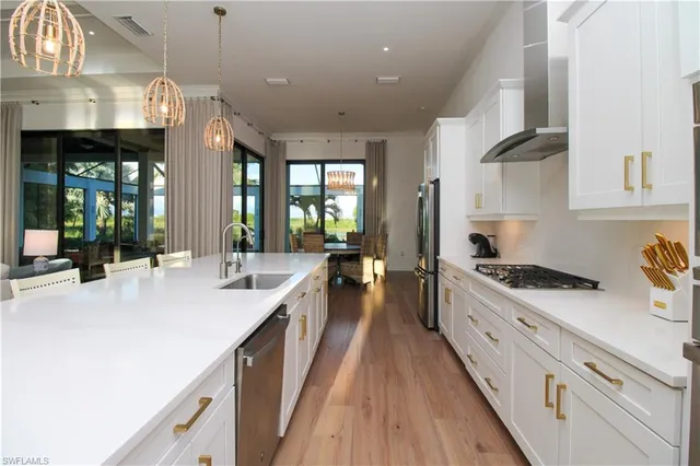 a large kitchen with stainless steel appliances lots of counter space and wooden floor