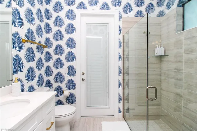 a bathroom with a sink toilet and shower