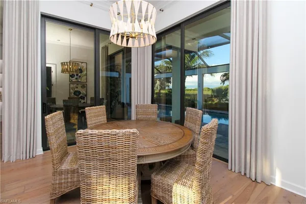 a view of a dining room with furniture and a chandelier