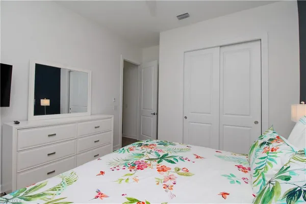 a bedroom with a bed and a dresser in it