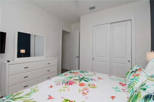 a bedroom with a bed and a dresser in it