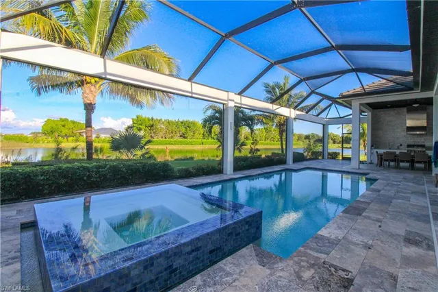 a view of a patio with a table and chairs under an umbrella
