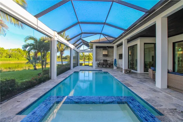 a swimming pool with patio outdoor seating and yard